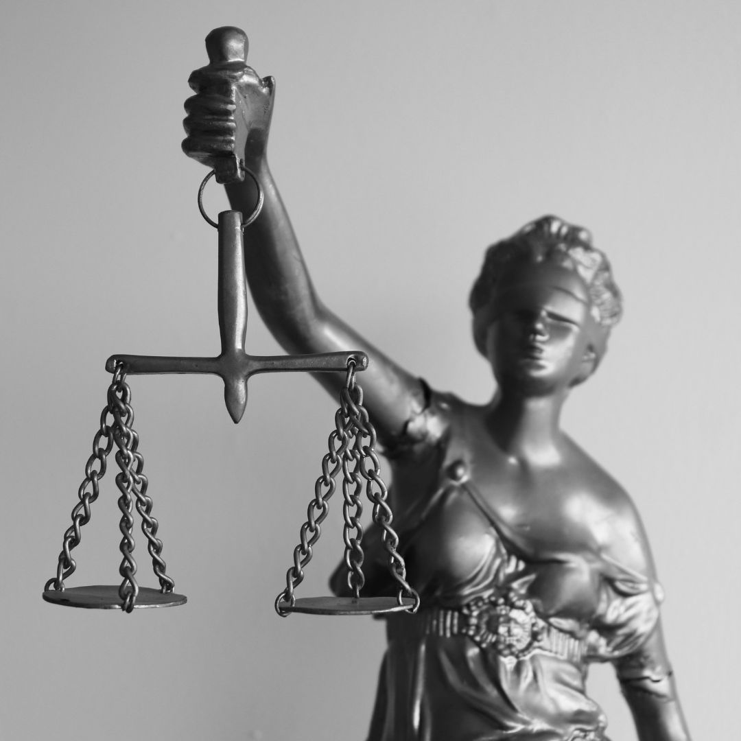 Silver statue holding scales